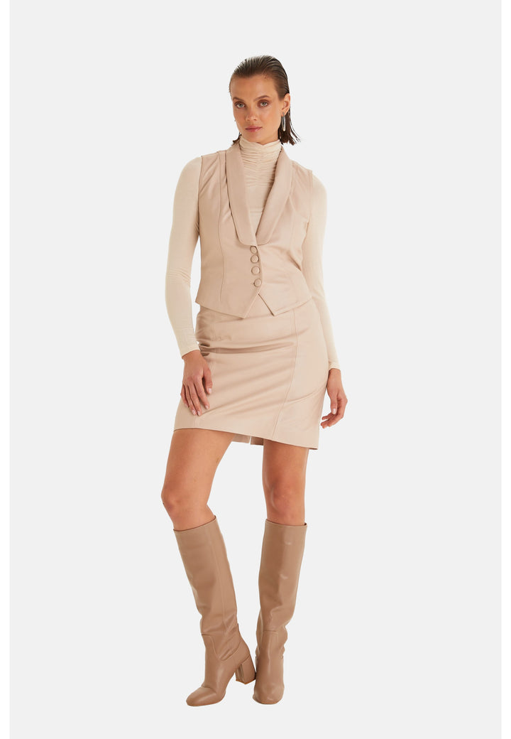Woman wearing beige leather vest outfit