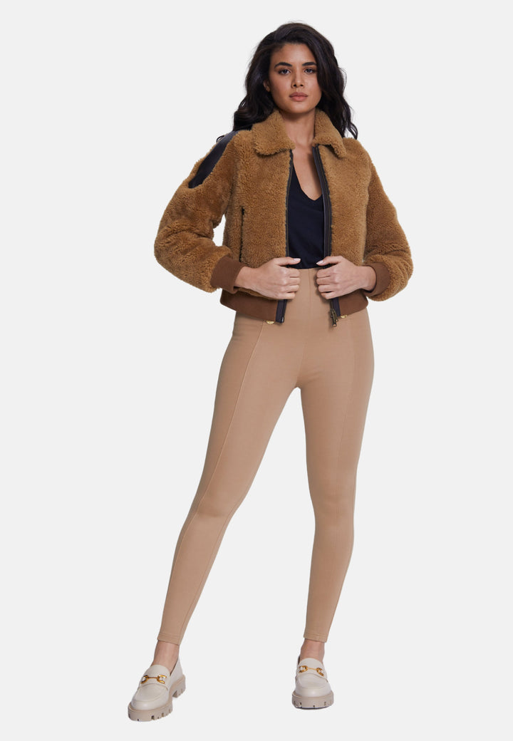 Woman wearing camel sheepskin teddy jacket