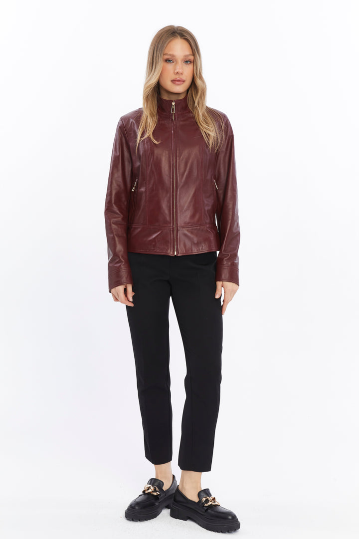 Woman wearing burgundy leather jacket - black pants