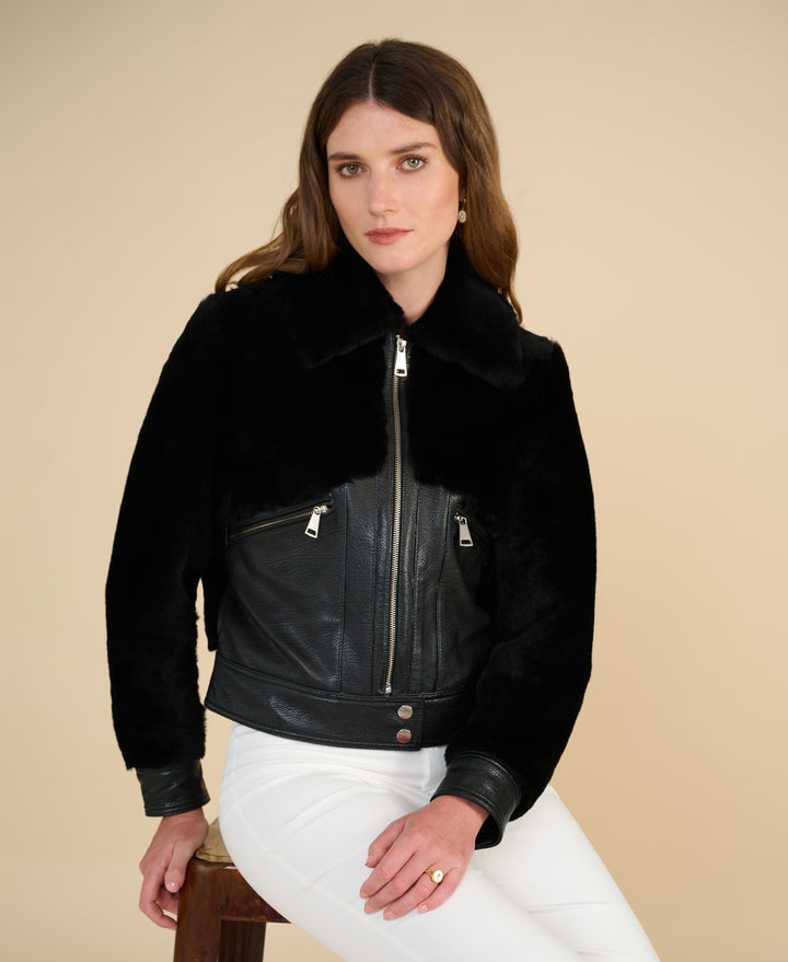 Emery black leather and shearling jacket styled seated for Fall Winter 2026 fashion