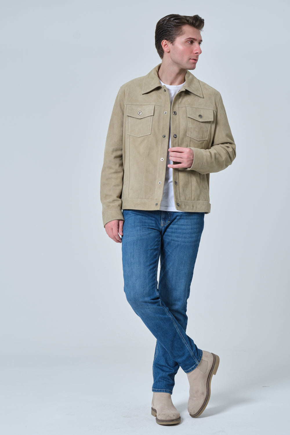 Male model wearing Enzo men's sage green suede jacket with blue jeans and beige suede boots front full view