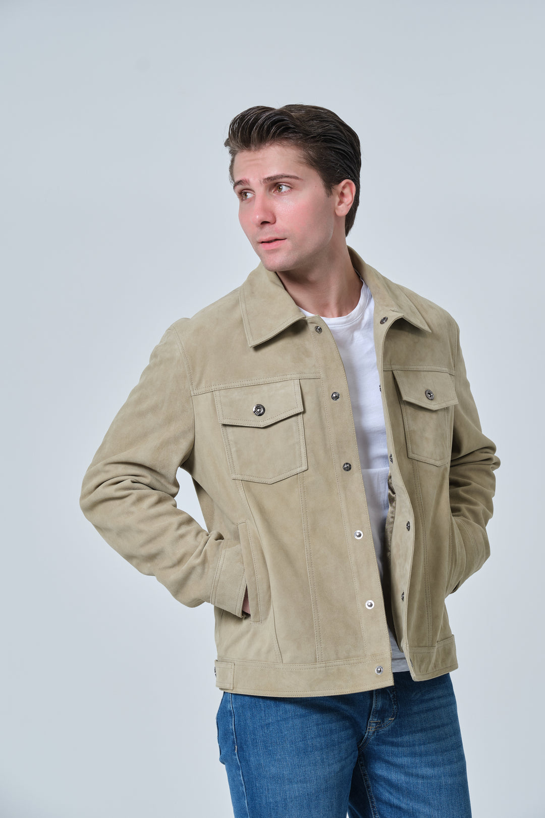 Close-up lifestyle image of Enzo men's sage green suede jacket with flap chest pockets and snap buttons