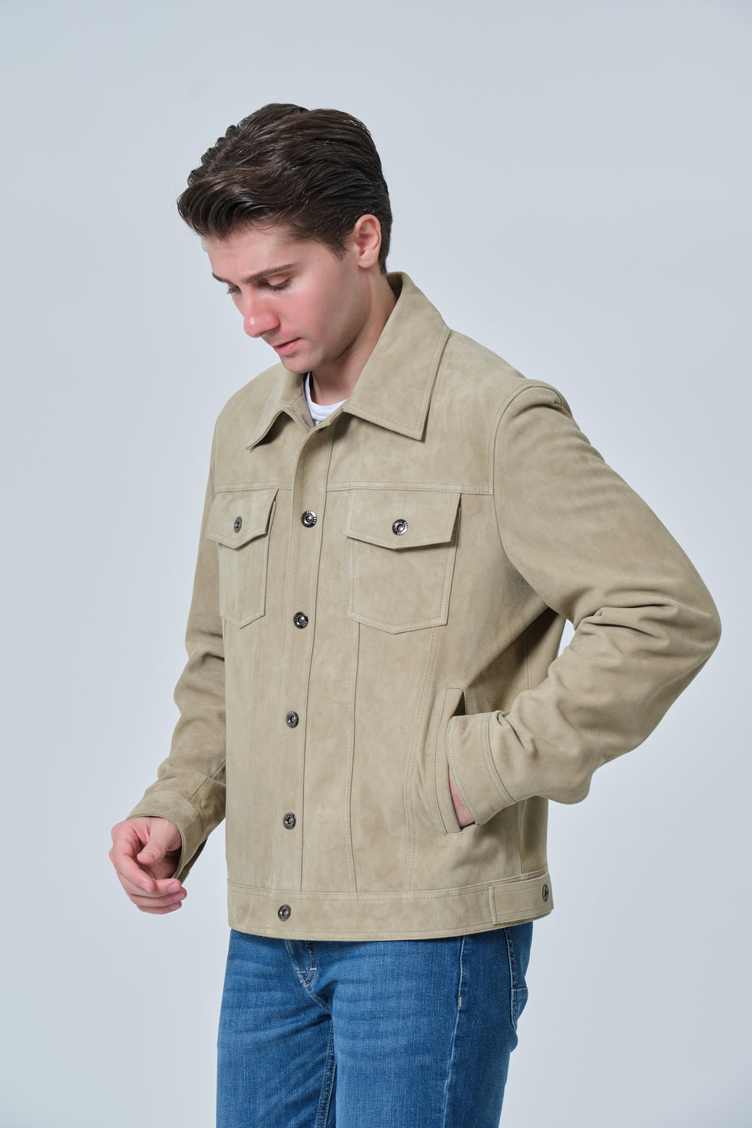 Side profile of Enzo men's sage green suede jacket styled with denim jeans