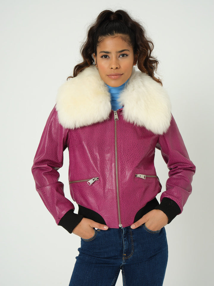 Woman wearing pink bomber jacket