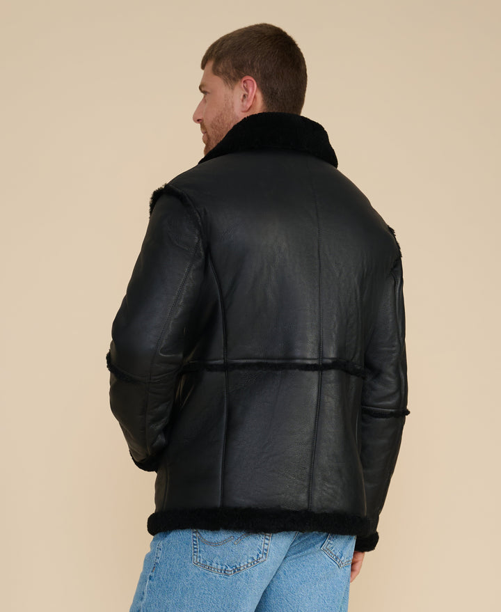 Man wearing black shearling jacket (back)