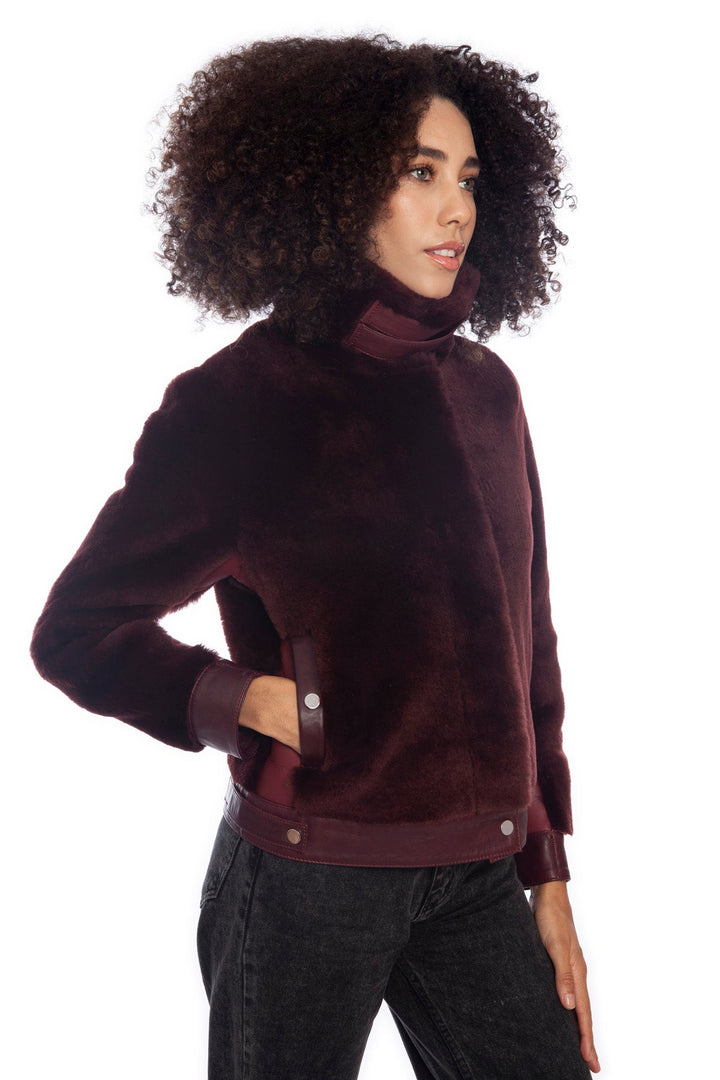 Woman wearing burgundy shearling jacket