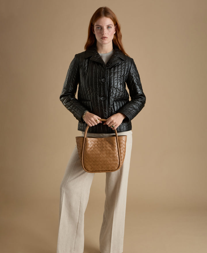 Woman wearing black quilted leather coat