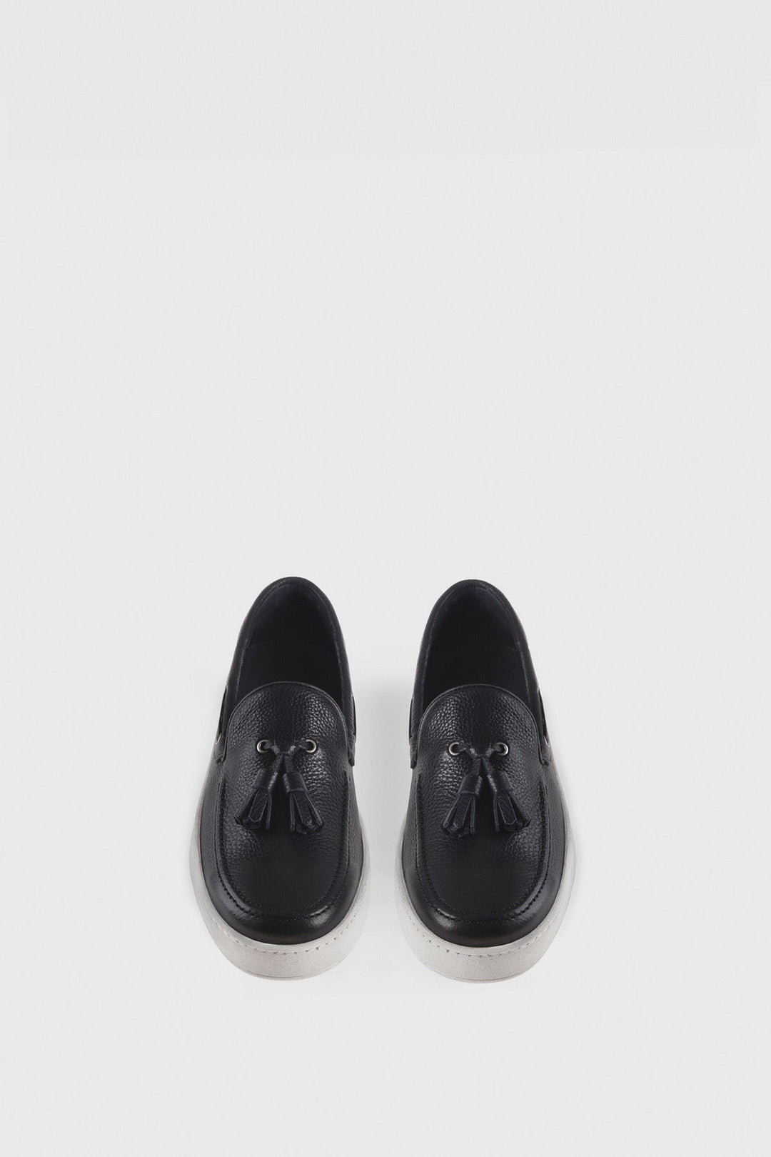 Navy leather tassel loafers on white