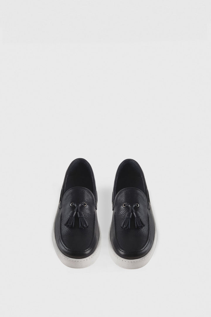 Navy leather tassel loafers on white