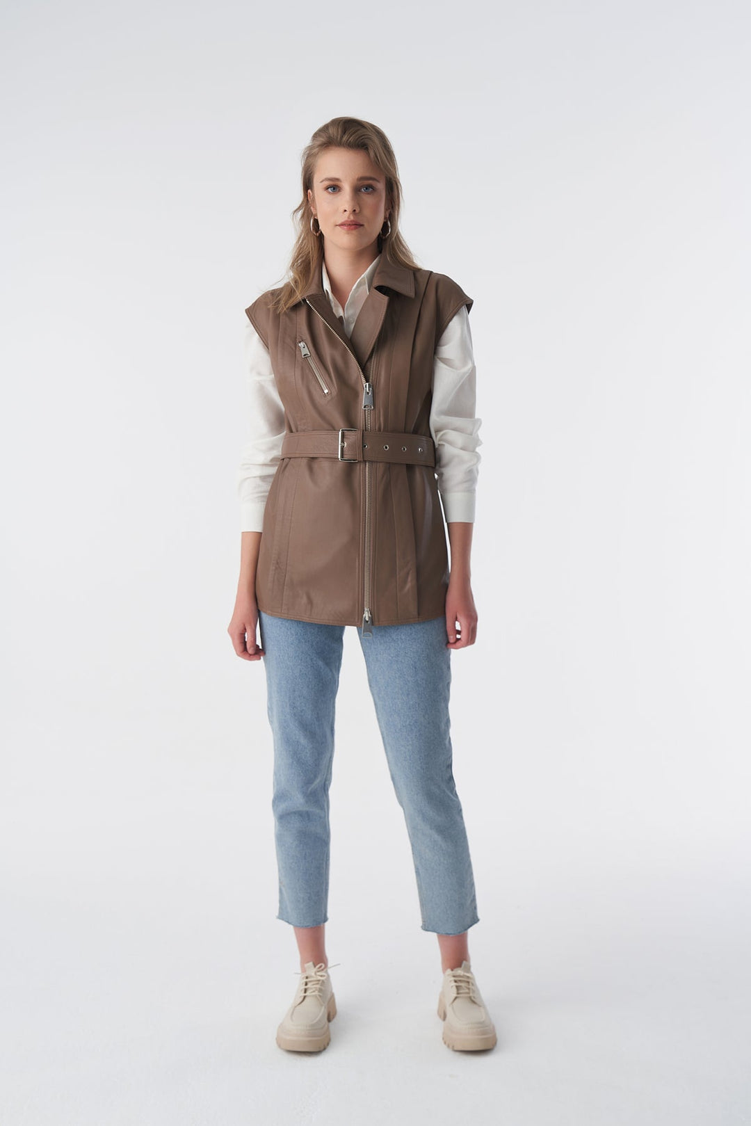 Woman wearing brown leather vest
