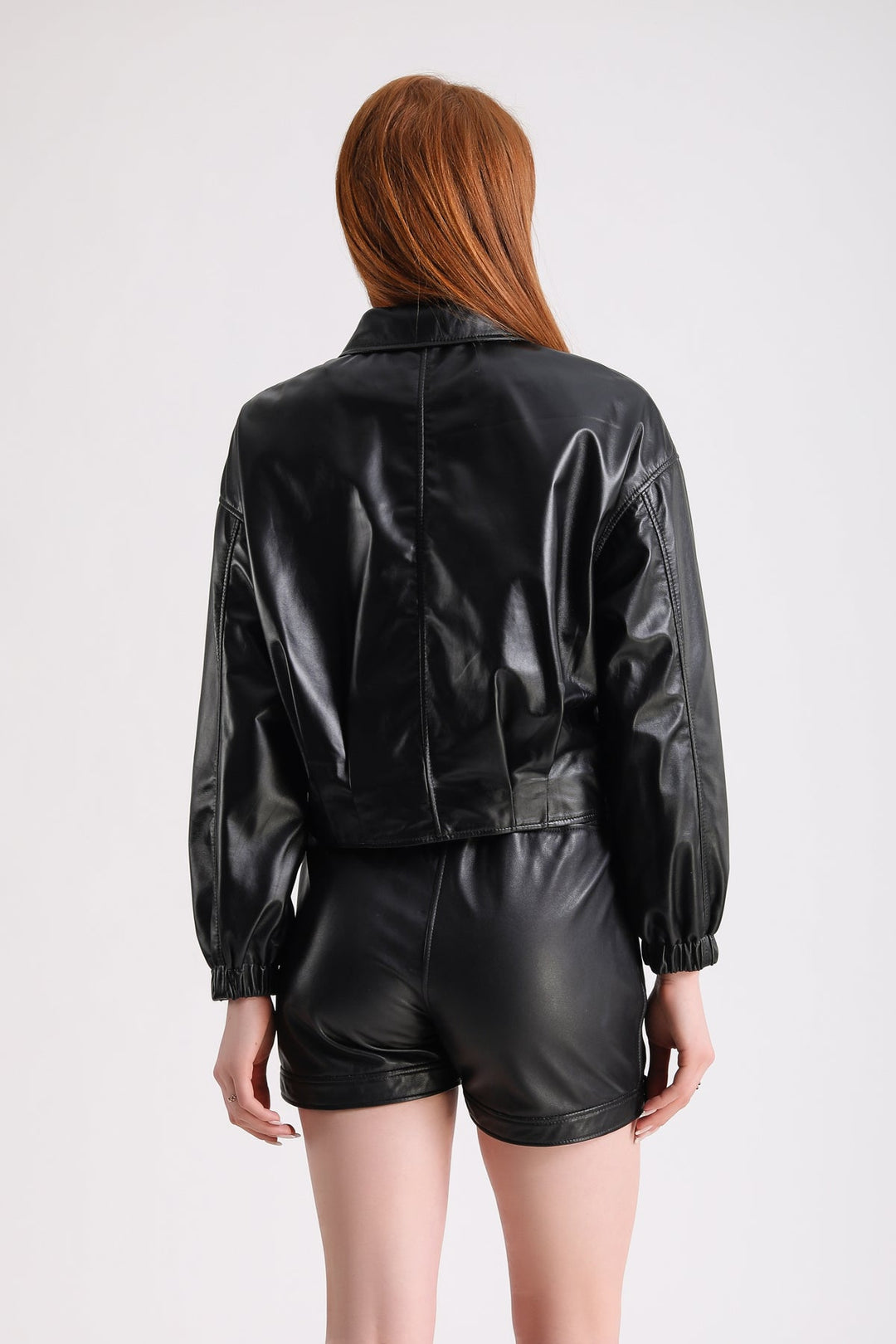 Woman wearing black cropped leather jacket