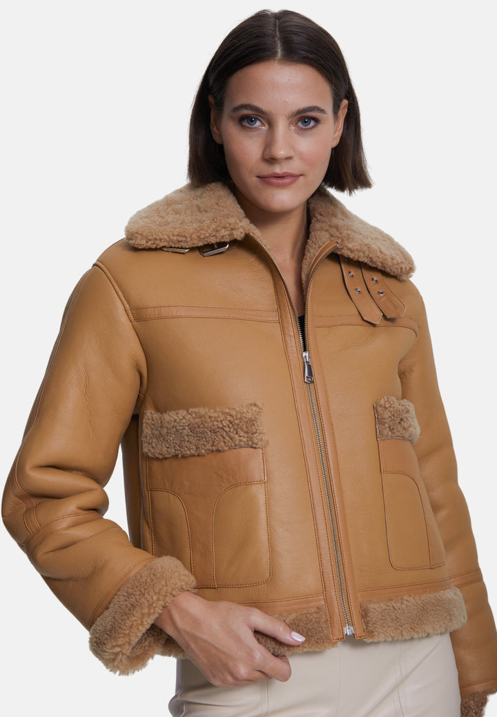 Woman wearing beige sheepskin jacket