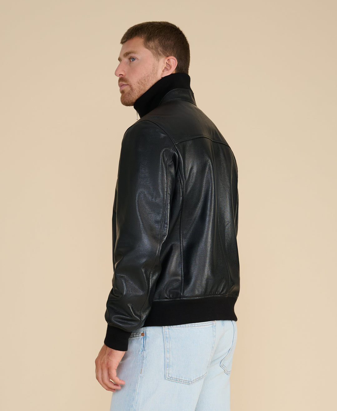 Male model wearing black leather jacket (back)