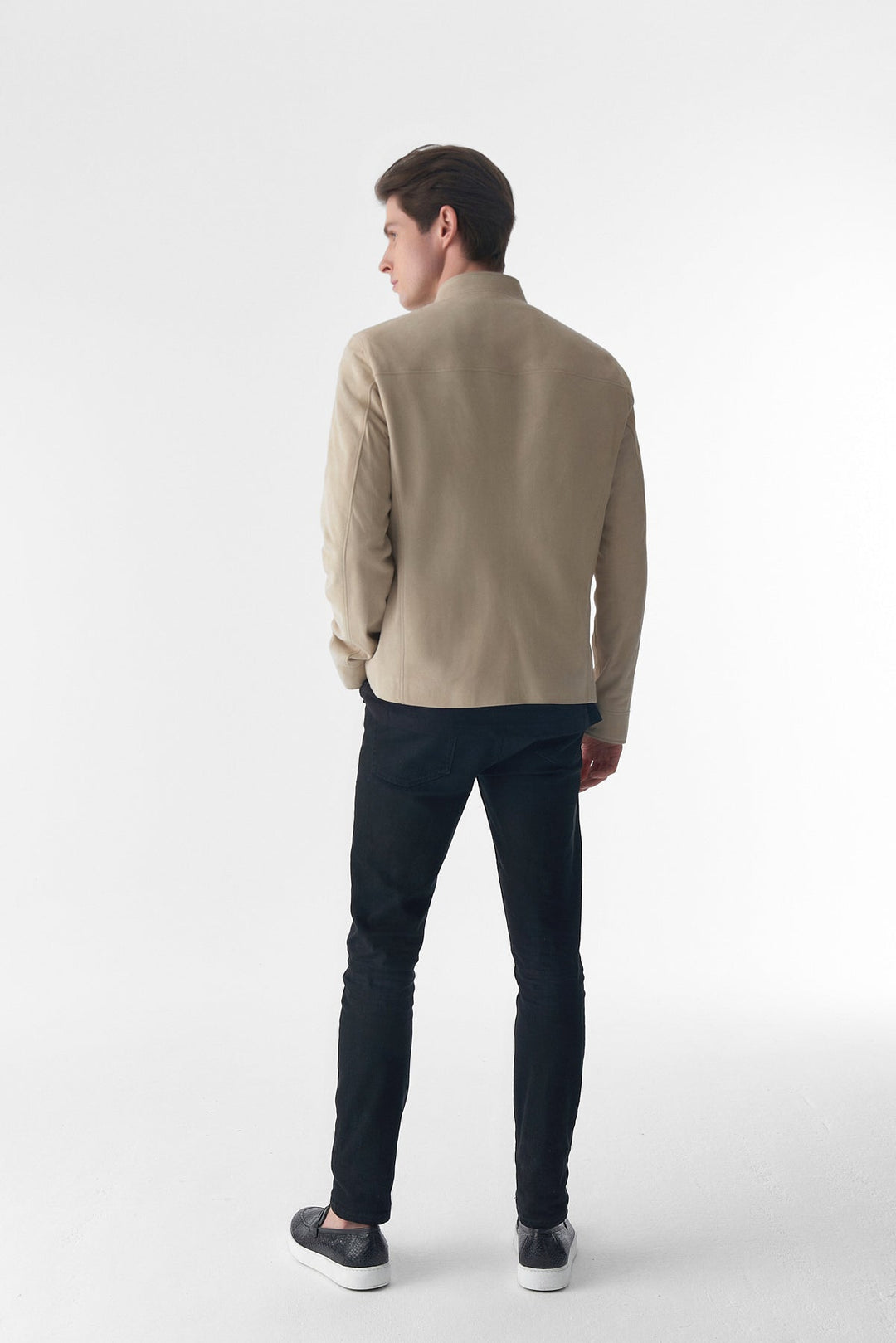 Man wearing beige suede jacket - back view
