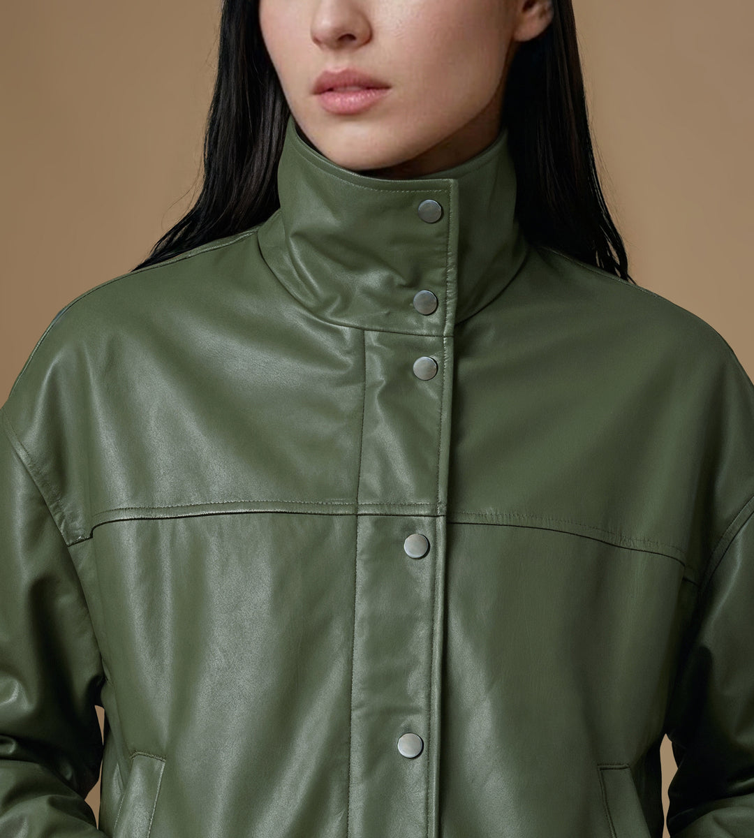 Close-up khaki leather jacket snap buttons funnel neck detail