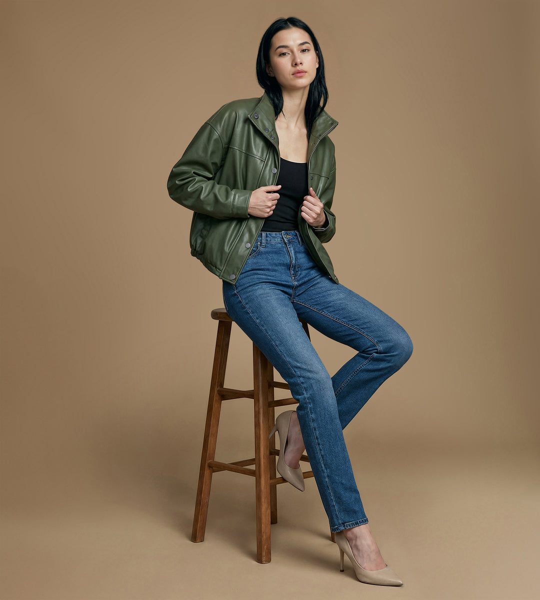 Full body look khaki leather jacket styled with denim