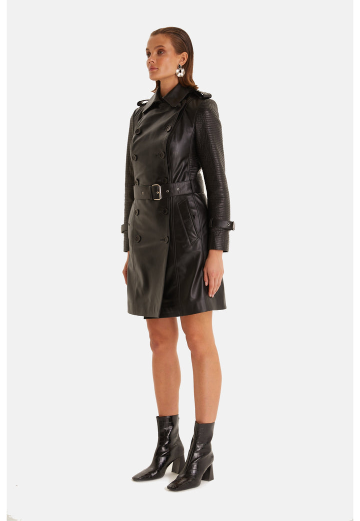 Three-quarter view of the Greenwich black leather trench coat with a defined waist and buckled cuff straps.