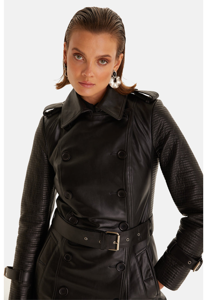 Detail of the Greenwich black leather trench coat showing textured sleeves, double-breasted buttons and buckle belt