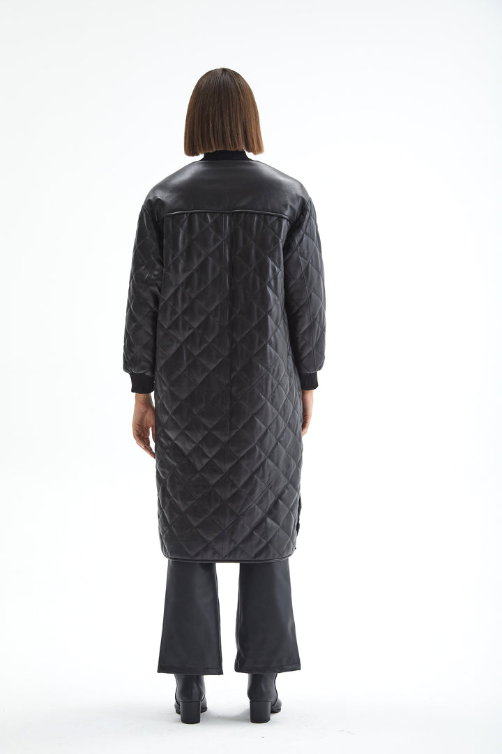 Back view of the Kensington black quilted leather coat showing the smooth upper-back panel and longline hem