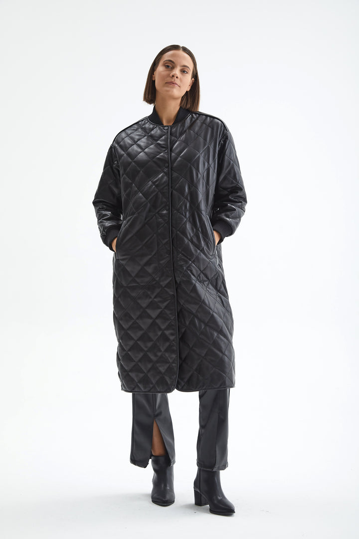 Kensington black quilted leather coat styled with black leather pants and ankle boots.