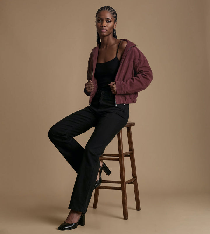 Burgundy suede jacket styled with black outfit modern look