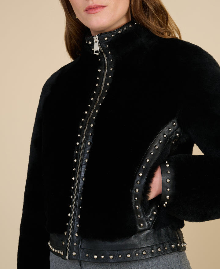 Harper black studded shearling jacket close up showing leather trim and stud details