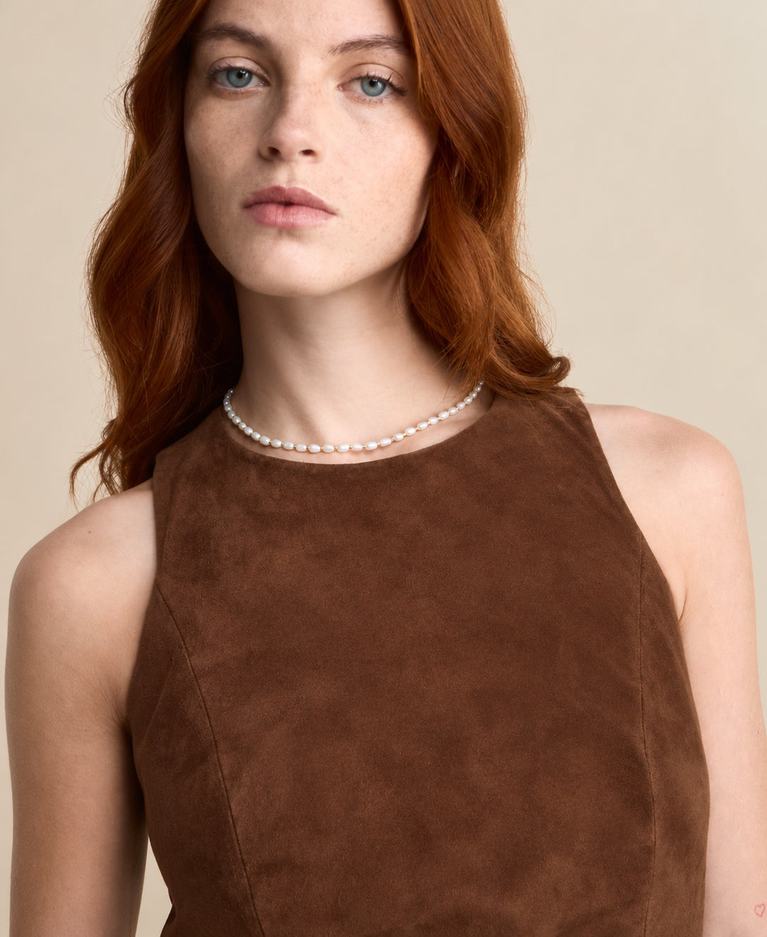 Close-up of the Helene Suede Dress in chestnut brown, showing the round neckline and suede texture.
