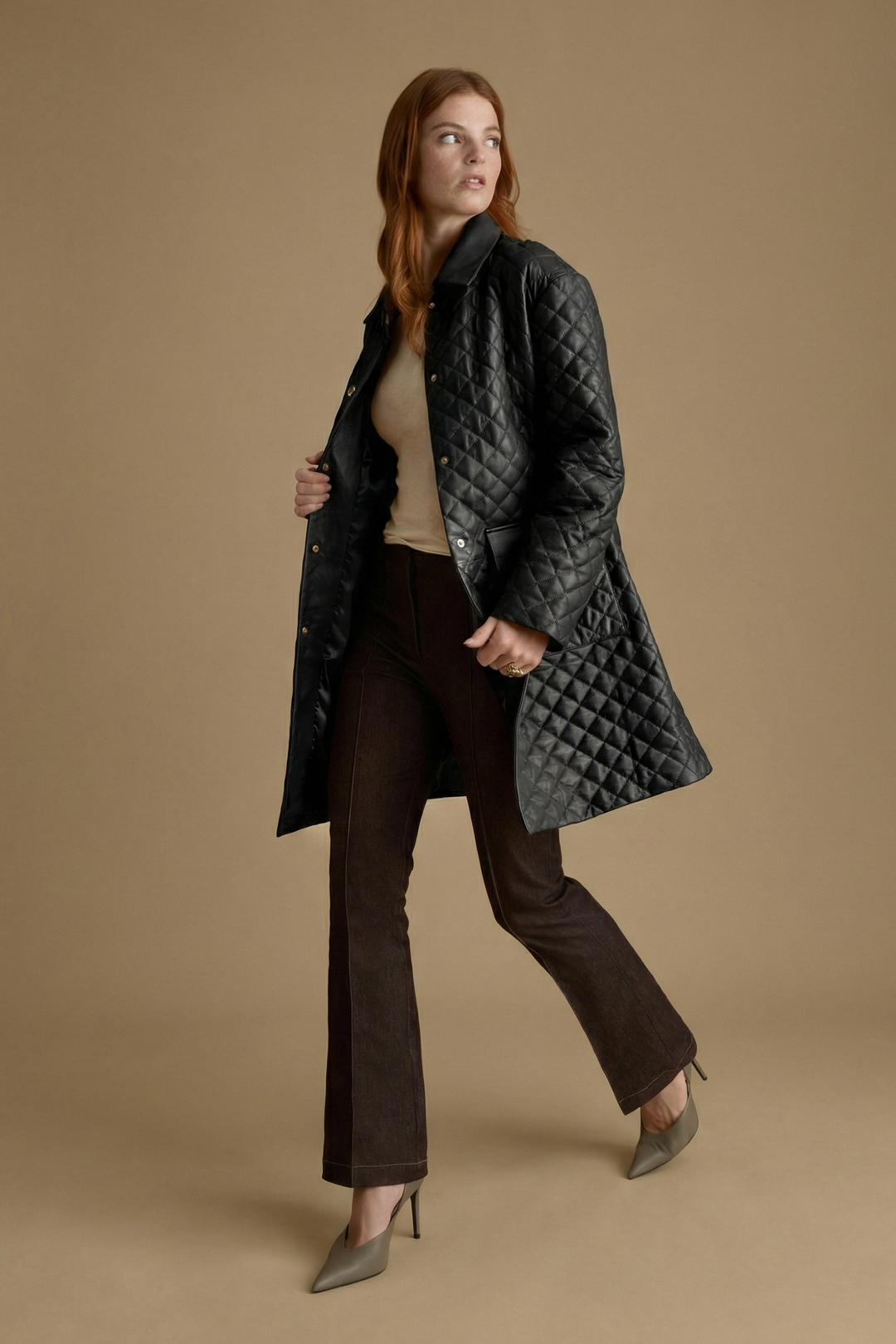 Side angle of luxury black quilted leather coat crafted from British leather