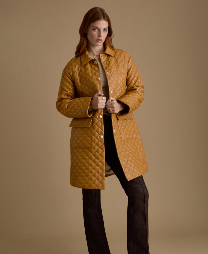 Full-length Holland caramel quilted leather coat styled with tailored dark trousers