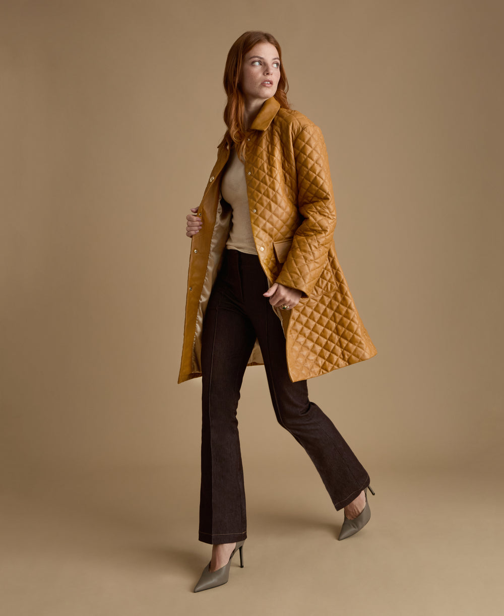 Side view of luxury caramel quilted leather coat crafted from British leather