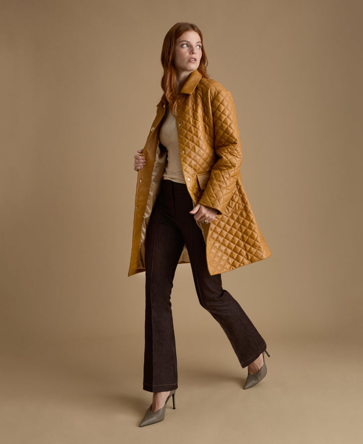Side view of luxury caramel quilted leather coat crafted from British leather