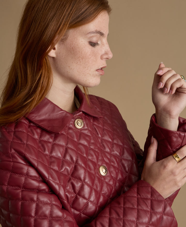 Close-up detail of Holland light burgundy quilted leather coat crafted from British leather