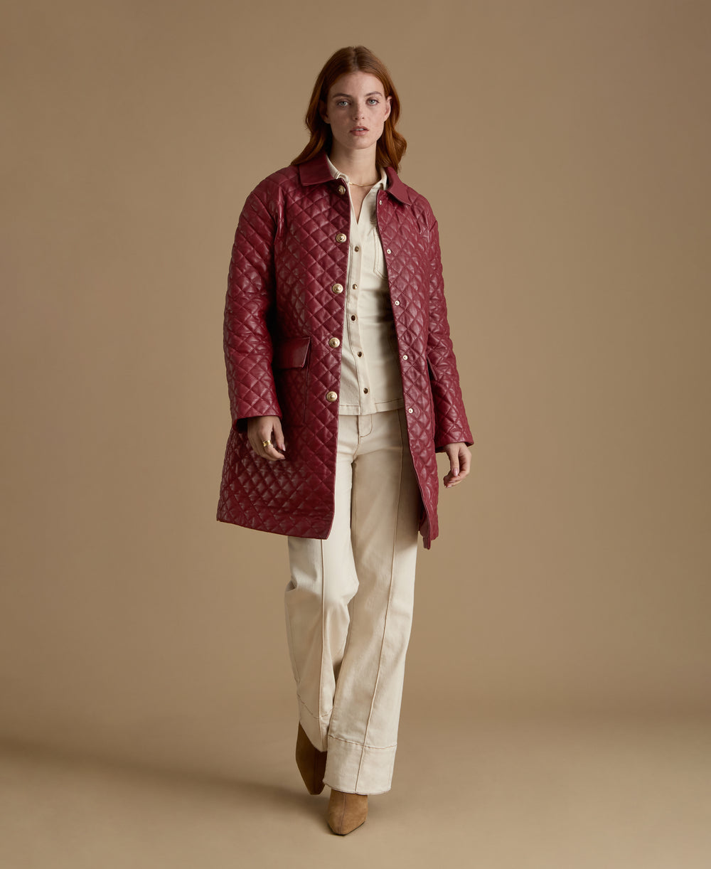 Woman wearing Holland light burgundy quilted leather coat from FURNIQ UK Fall Winter 2026/27 collection