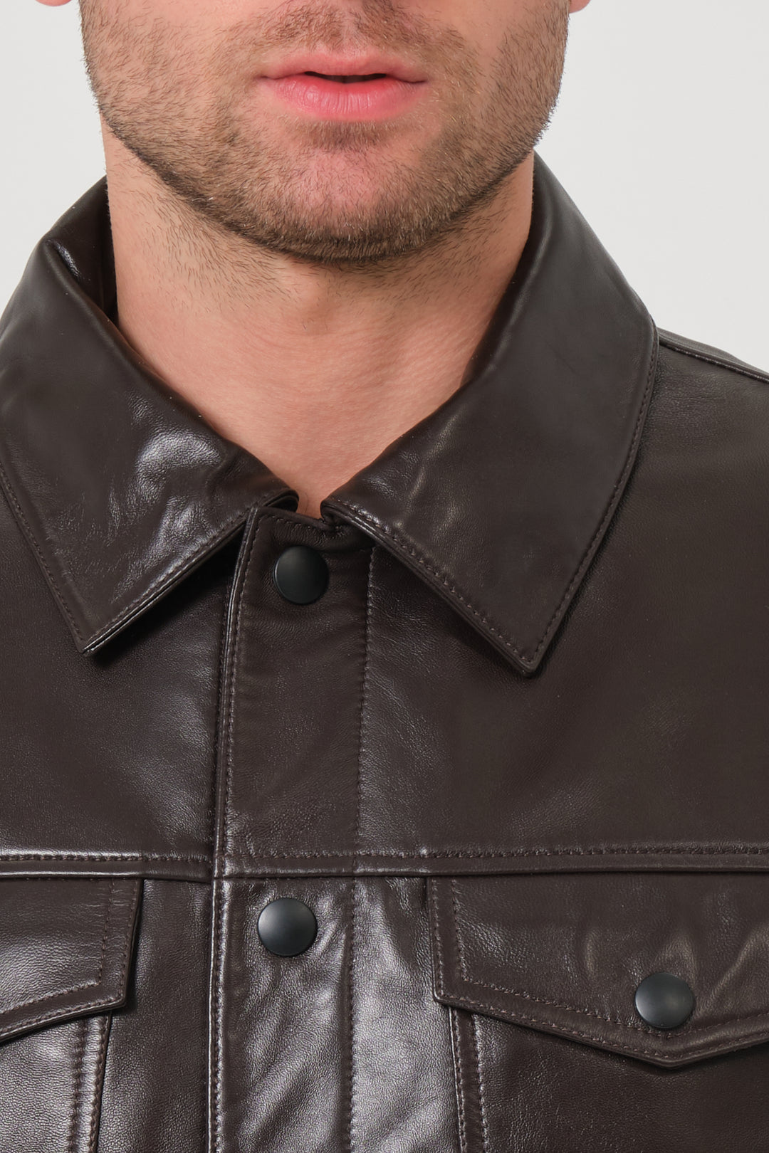 Close up brown leather jacket collar and snap button detail