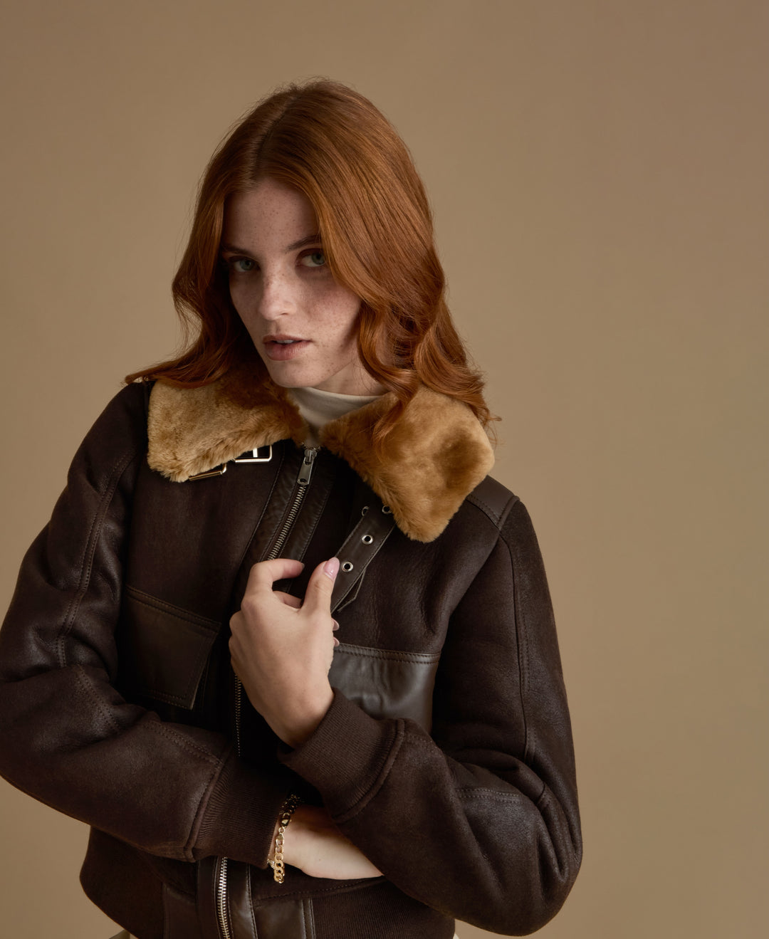 Close-up of Mabel dark brown leather jacket with plush genuine ginger shearling collar