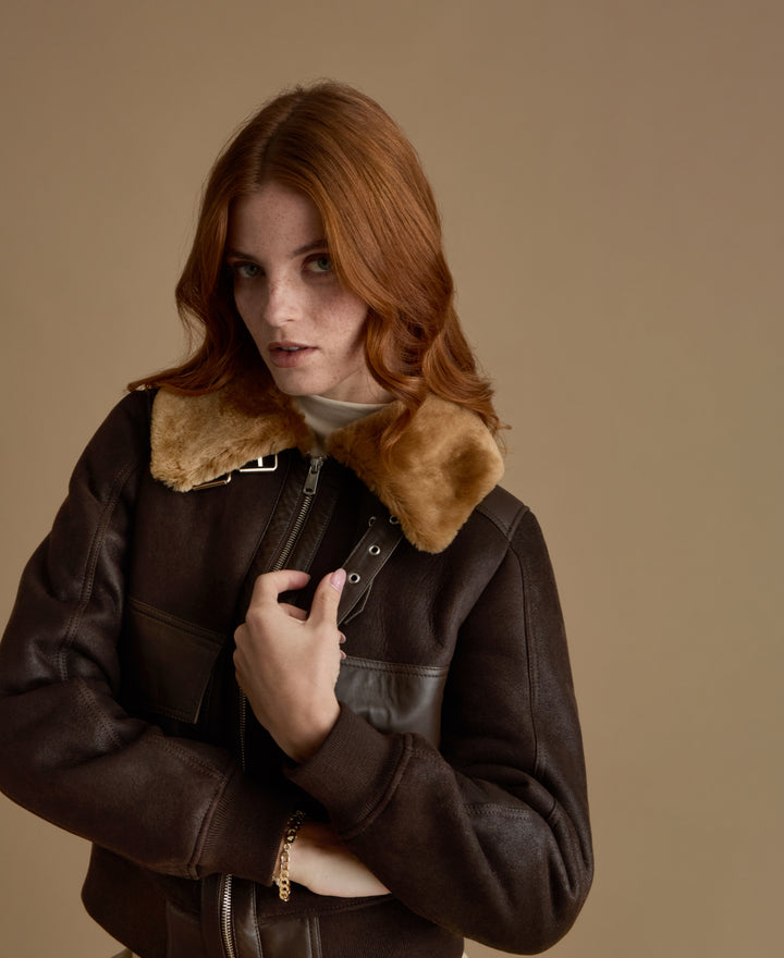 Close-up of Mabel dark brown leather jacket with plush genuine ginger shearling collar