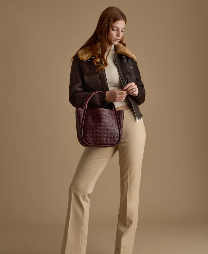 Luxury women's dark brown leather shearling jacket handcrafted for the FURNIQ FW26 collection