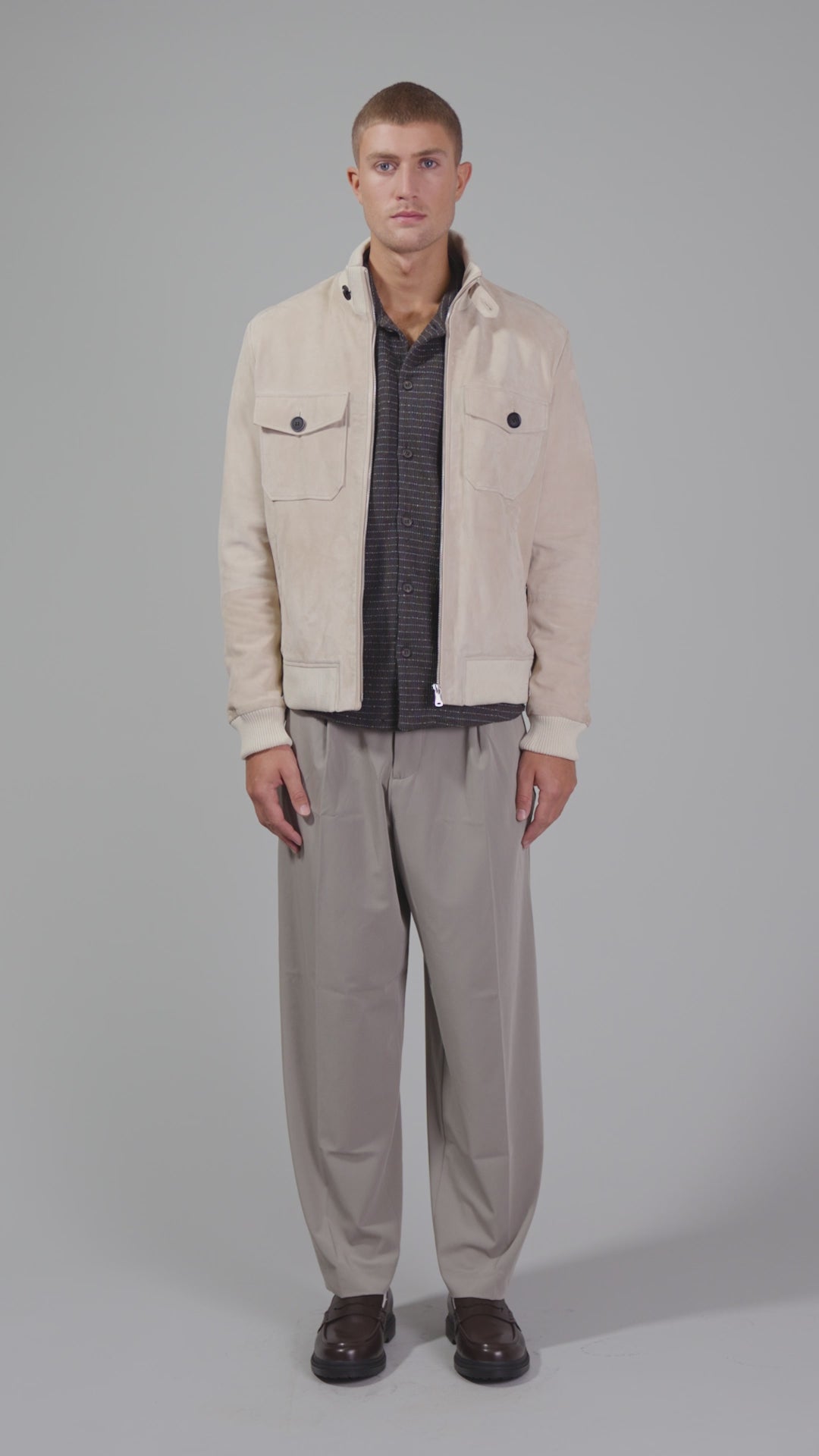 Video of man wearing beige suede jacket with high neck