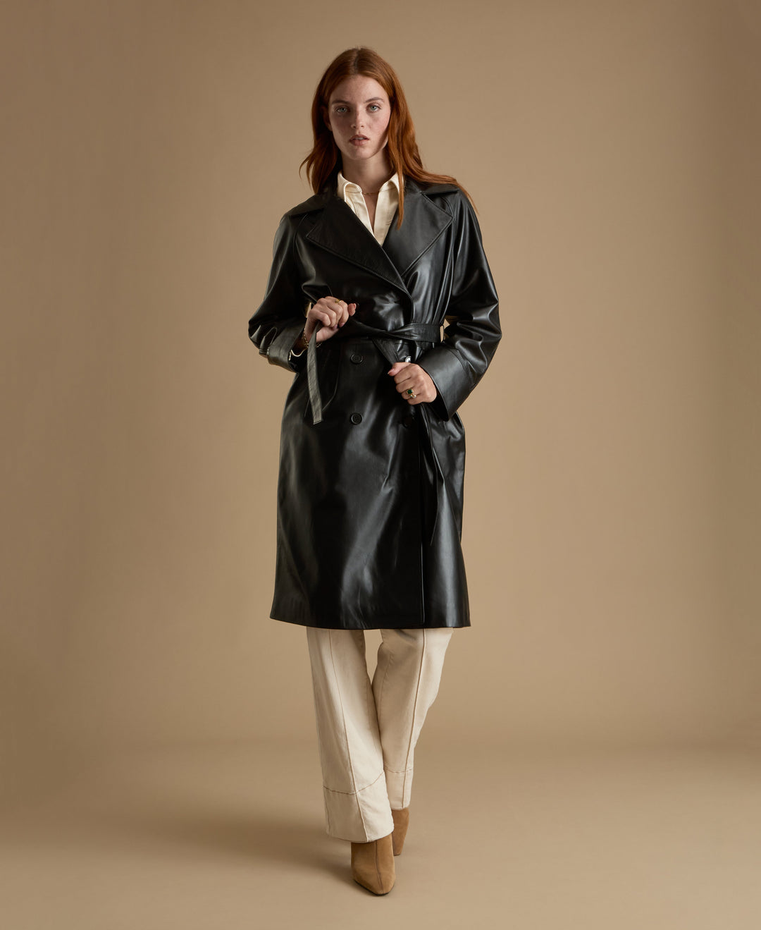 Sloane black leather trench coat full length belted leather coat walking view
